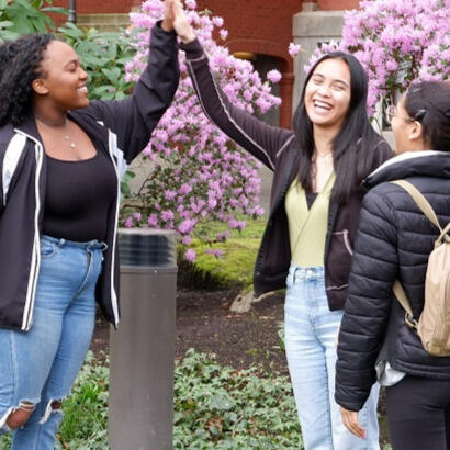 Two SPU students high fiving