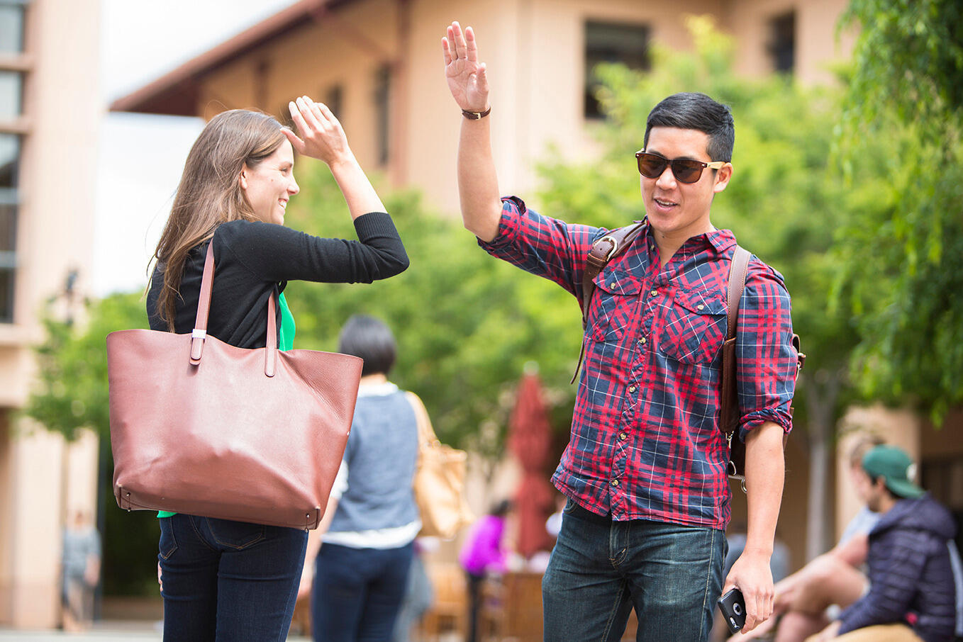 Two GSB students high-fiving