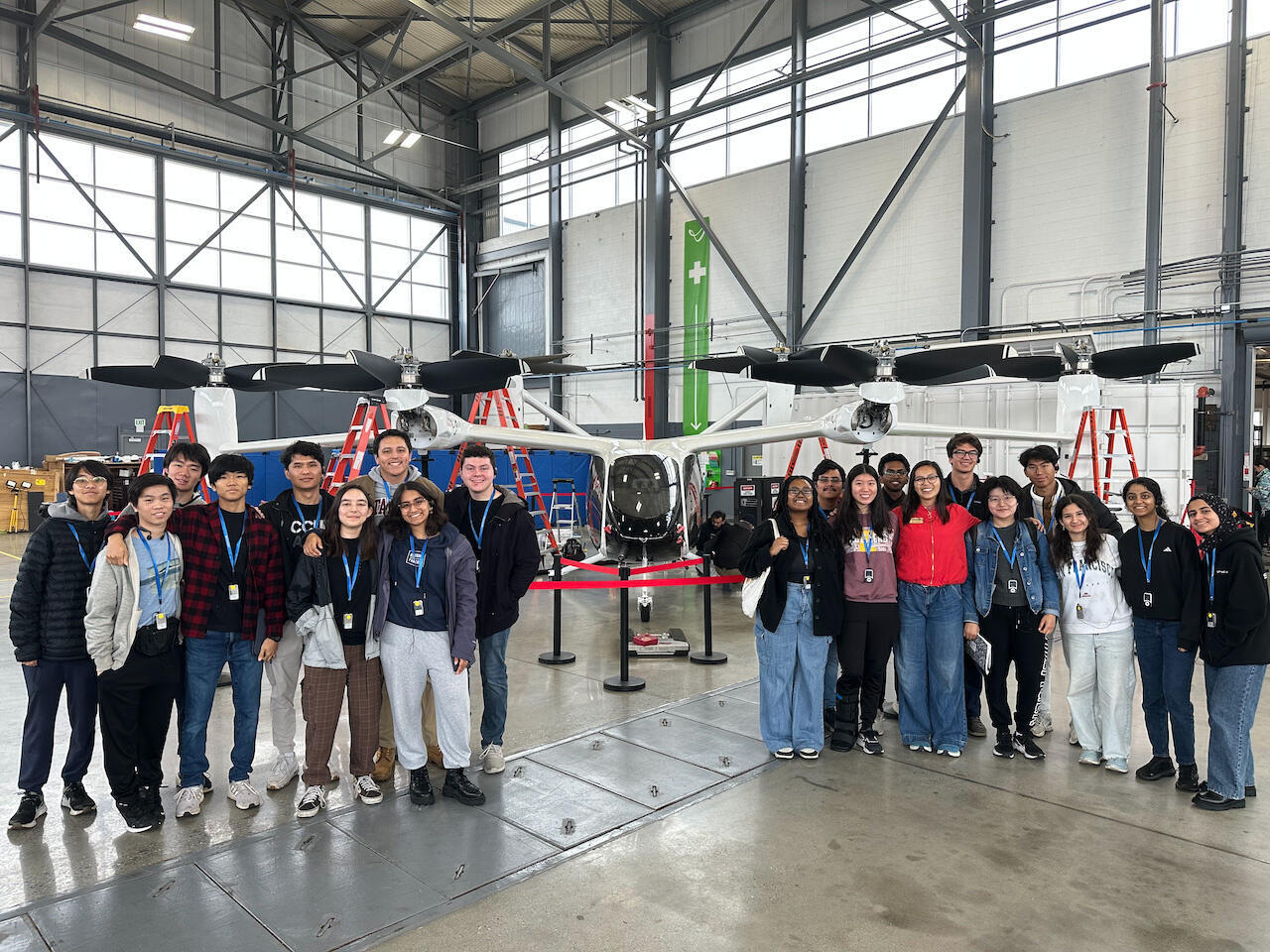 Students from the Stanford Space Initiative pose in front of a drone