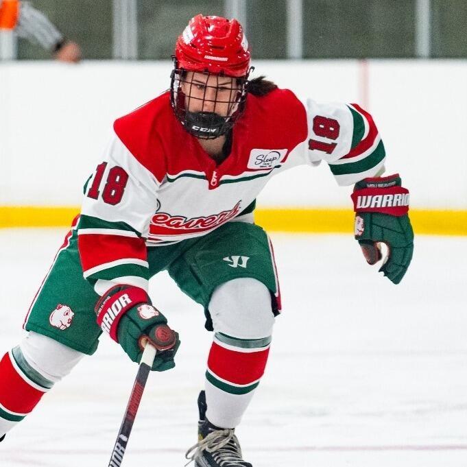 Feamle MSU hockey player in action on the ice