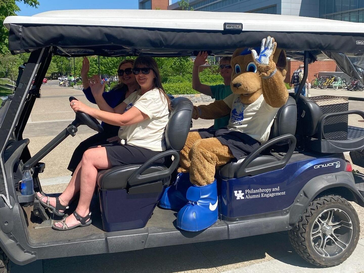 Students holding up black One Day for UK branded t-shirts